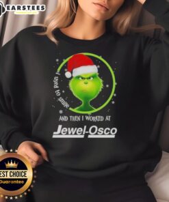 Premium Grinch Christmas sweatshirt featuring 'I Used to Smile and Then I Worked at Jewel Osco' humorous design.