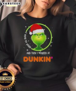 Premium Grinch sweatshirt featuring 'I Used to Smile and Then I Worked at Dunkin Donuts' design, perfect for holiday wear.