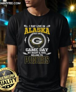 Premium Green Bay Packers T-shirt featuring 'I May Live In Alaska But On Game Day My Heart And Soul Belongs To' design.
