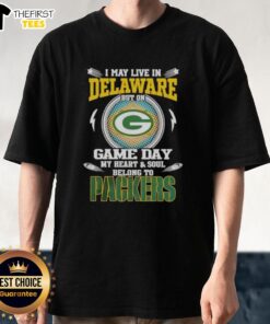 Premium I May Live In Delaware But On Game Day My Heart And Soul Belongs To Green Bay Packers T-Shirt displayed on a hanger.
