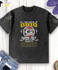 Premium washed t-shirt featuring 'I May Live In Ohio, But My Heart Belongs To Green Bay Packers' for avid fans.