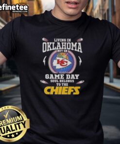 Premium living in Oklahoma game day t-shirt featuring Kansas City Chiefs logo and vibrant design for fans.