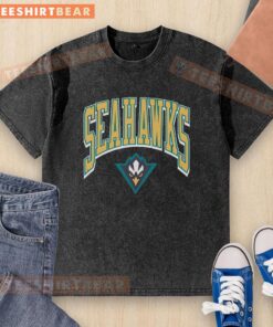 Premium North Carolina at Wilmington Walk Tall washed t-shirt displayed on a wooden background, showcasing its soft fabric.
