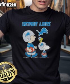 Alt Text: Premium Peanuts Snoopy and Charlie Brown X Detroit Lions football T-shirt featuring vibrant graphics and team colors.