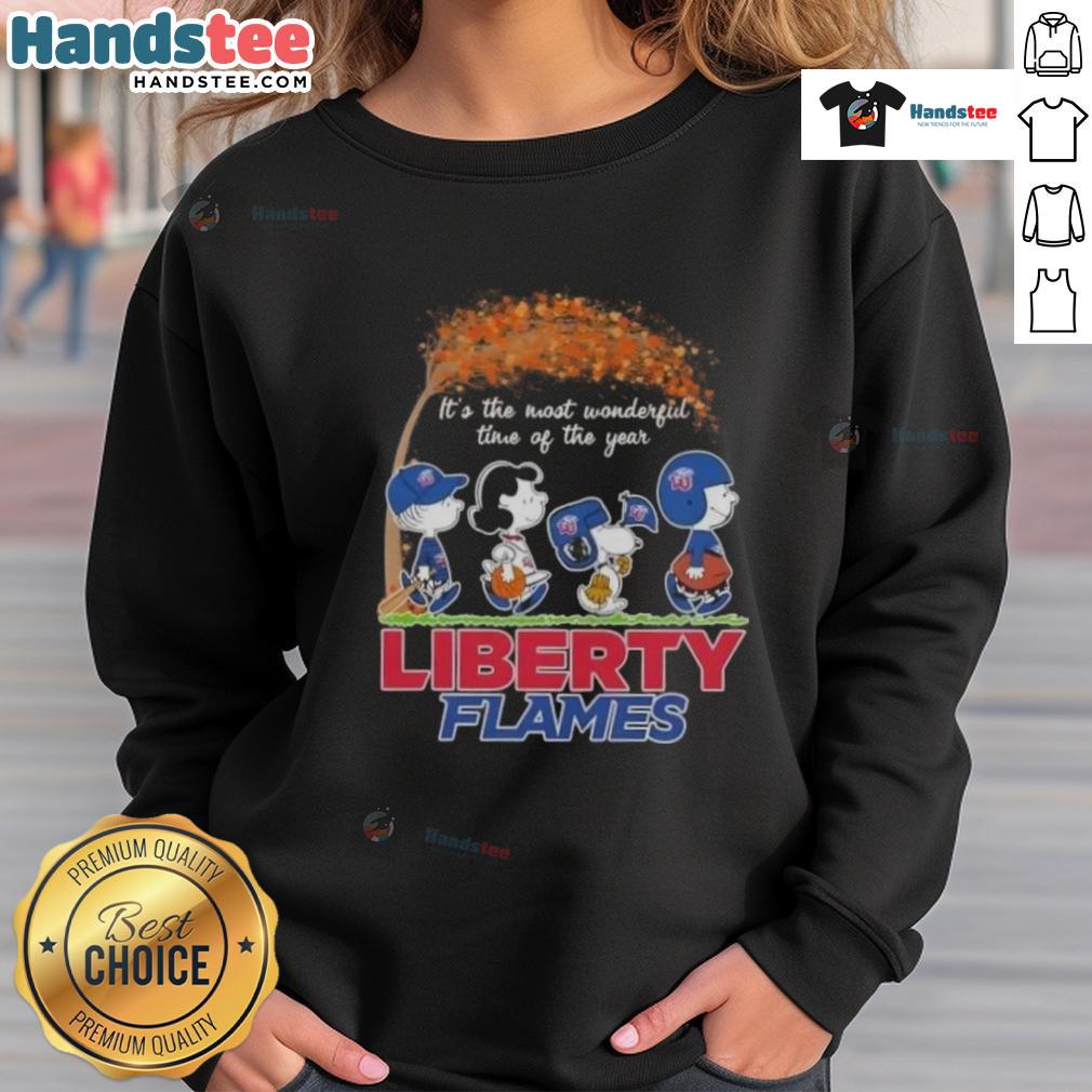 premium-peanuts-snoopy-and-friends-its-the-most-wonderful-time-of-the-year-liberty-flames-sweatshirt Alt Text: Premium Peanuts sweatshirt featuring Snoopy and friends celebrating the holiday season with festive Liberty Flames design.