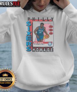 Premium Philadelphia 76ers trading card featuring Joel Embiid on a stylish hoodie, perfect for sports fans.