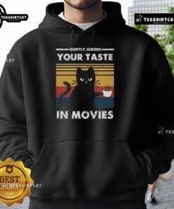 Premium hoodie features 'Quietly Judges Your Taste In Movies' design, perfect for movie lovers and cozy comfort.
