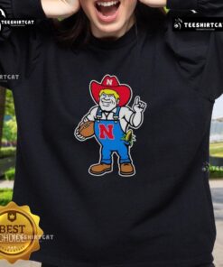 Andrew Whitworth and Ryan Fitzpatrick in Nebraska Huskers Herbie mascot sweatshirts at a football event.