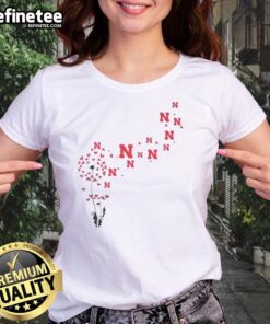 Pretty dandelion flower design with Nebraska Huskers football logo on a ladies' tee shirt, perfect for fans.