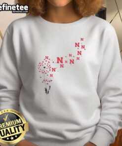 Pretty dandelion flower design on Nebraska Huskers football logo sweatshirt, perfect for fans and casual wear.