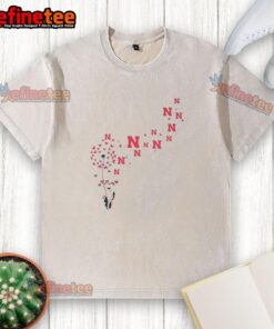 Alt Text: Pretty dandelion flower design on a Nebraska Huskers football logo washed t-shirt, perfect for fans.