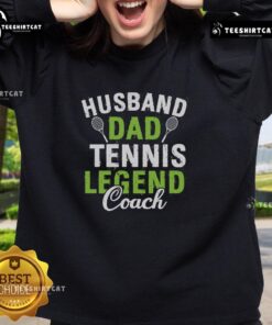Pretty husband and dad wearing a Tennis Legend Coach sweatshirt on the court, showcasing style and passion for tennis.