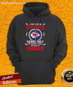 Woman wearing a Kansas City Chiefs hoodie showing team spirit, despite living in Indiana, perfect for game day.