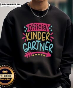 Pretty kindergartner girl wearing a cute sweatshirt on her first day of kindergarten, smiling with a backpack.
