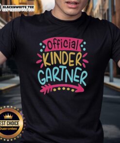 Alt Text: Pretty kindergartner girl wearing a cute T-shirt on her first day of kindergarten, smiling brightly.