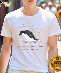 Pretty penguins walking in the rain on a 'I Know The Wind Is Strong But So Are You' T-shirt design.
