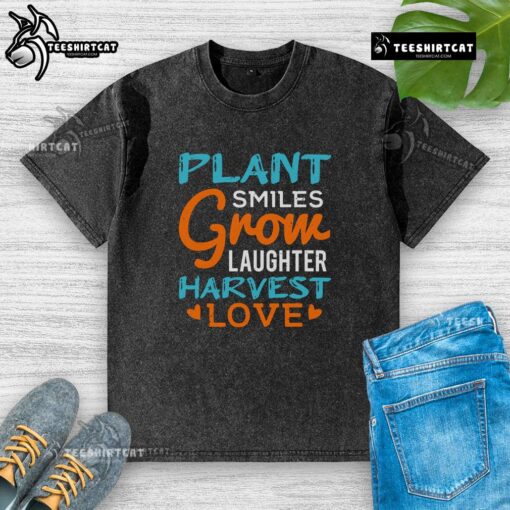 Colorful 'Pretty Plant Smiles Grow Laughter Harvest Love' washed t-shirt displayed on a wooden table, perfect for plant lovers.