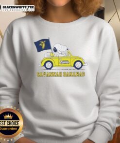 Pretty Snoopy driving a car on a Savannah Bananas sweatshirt, showcasing a fun and playful design.