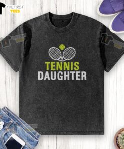 Pretty daughter wearing a washed tennis-themed t-shirt, smiling on a sunny day at the park.