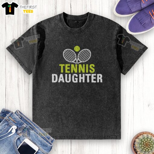 Pretty daughter wearing a washed tennis-themed t-shirt, smiling on a sunny day at the park.