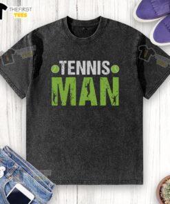 Stylish man in a washed t-shirt playing tennis on a sunny court, showcasing athletic wear and a competitive spirit.
