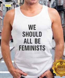 Pretty We Should All Be Feminists tank top featuring a bold feminist slogan in vibrant colors on a casual background.