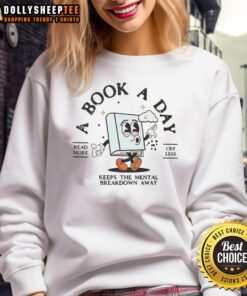 Cozy retro sweatshirt featuring 'Bookish Mental Health Book a Day' design, perfect for book lovers and self-care enthusiasts.