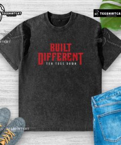 Top Built Different Ten Toes Down washed t-shirt displayed on a hanger, showcasing its casual style and soft fabric.