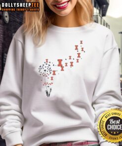 Top view of a dandelion flower on an Illinois Fighting Illini football logo sweatshirt in vibrant colors.