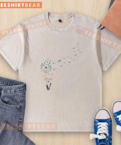 Top view of a Miami Dolphins football logo on a washed t-shirt featuring a dandelion flower design.