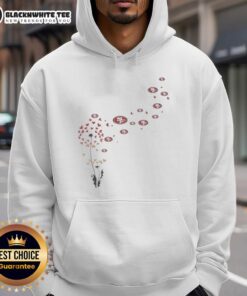 Alt Text: Top view of a dandelion flower with a San Francisco 49ers football logo hoodie in the background.