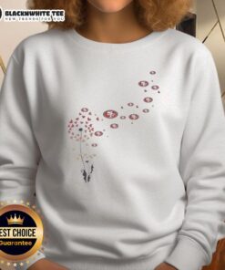 Alt Text: Top view of a dandelion flower design on a San Francisco 49ers football logo sweatshirt, showcasing team spirit.