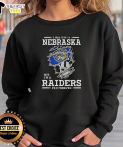 Cozy 'I May Live in Nebraska But I'm a Raiders Fan Forever' sweatshirt showcasing team pride and style.