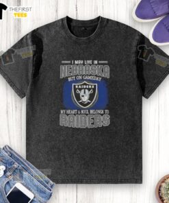 Alt Text: Washed t-shirt with 'I May Live In Nebraska But On Gameday My Heart Belongs To Raiders' slogan for fans.