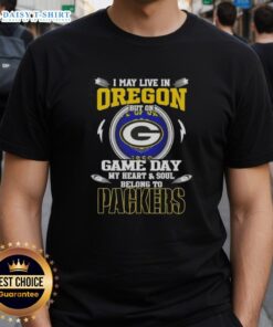 Man wearing 'I May Live In Oregon But My Heart Belongs To Green Bay Packers' T-shirt, showing team spirit on game day.