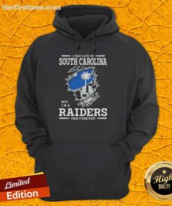 Cozy hoodie featuring 'I May Live In South Carolina But I'm A Raiders Fan Forever' design, perfect for Raiders fans.