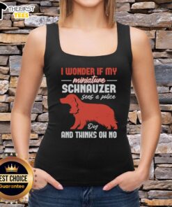 Miniature Schnauzer dog wearing a 'Oh No' tank top, looking curious and playful in a bright outdoor setting.