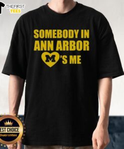 Alt Text: Top Michigan Somebody In Ann Arbor Loves Me T-Shirt featuring fun typography and vibrant colors, perfect for fans.