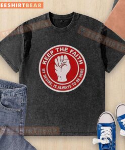 Alt Text: Top Nottingham Forest Keep The Faith Washed T-Shirt displayed on a hanger, showcasing its vibrant design and soft fabric.