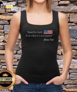 Charlie Kirk wearing a US flag tank top with the phrase 'Stand for Truth Even When It's Not Popular.'