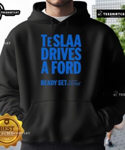Person wearing a 'Top Tesla Drives a Ford' hoodie, showcasing a fun automotive-themed graphic and stylish design.