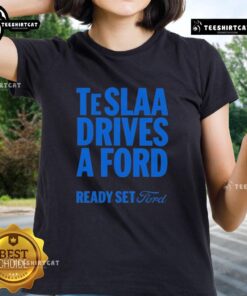 Top Tesla drives a Ford in a fun 'Ready Set Ford' ladies tee, showcasing a playful automotive theme.