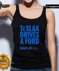 Alt Text: Top Tesla drives a Ford wearing a Ready Set Ford tank top, showcasing a fun fusion of brands and style.