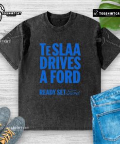 Alt Text: Top Tesla drives a Ford in a 'Ready Set Ford' washed t-shirt, showcasing a fun automotive twist and style.