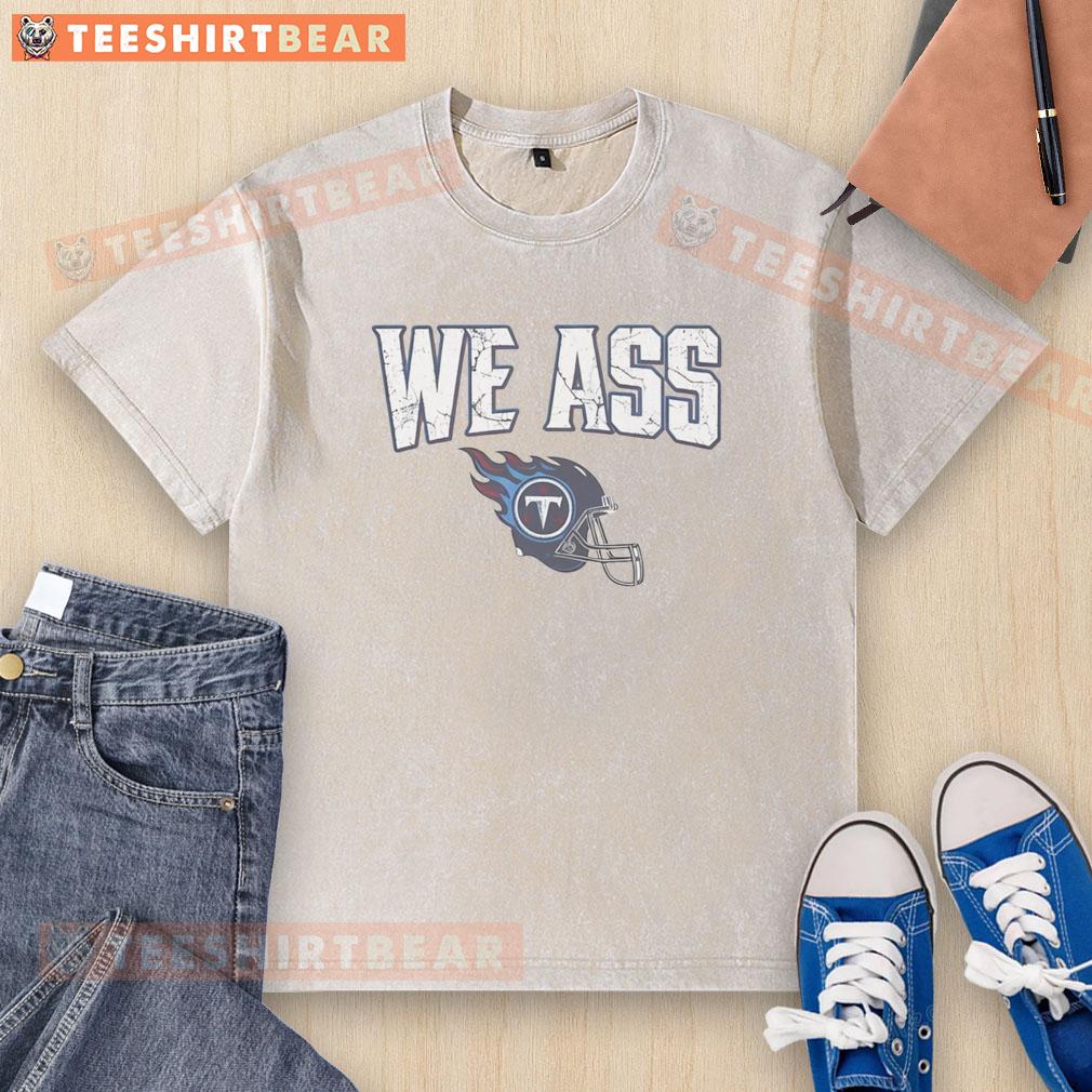 Top We Ass Tennessee Titans Football Helmet Washed T Shirt Alt Text: Tennessee Titans football helmet graphic on a washed t-shirt, perfect for fans and casual wear.