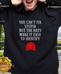 MAGA red hat sweatshirt with humorous slogan 'You Can't Fix Stupid' displayed prominently on a model.