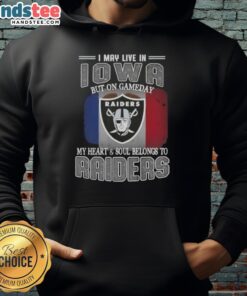 Person wearing an 'I May Live In Iowa But On Gameday My Heart And Soul Belongs To Raiders' hoodie, showcasing team pride.