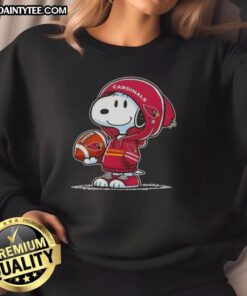 Snoopy in a hoodie, smiling at fans while wearing an Arizona Cardinals sweatshirt - Awesome Peanuts design.