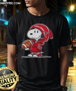 Alt Text: Peanuts Snoopy in hoodie smiling at fans, showcasing Atlanta Falcons T-shirt design, perfect for sports enthusiasts.