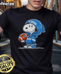 Alt Text: Snoopy in a hoodie smiling at fans on a Detroit Lions T-shirt, showcasing awesome Peanuts character design.